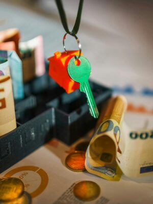 House key and euro bills depicting real estate and financial themes.